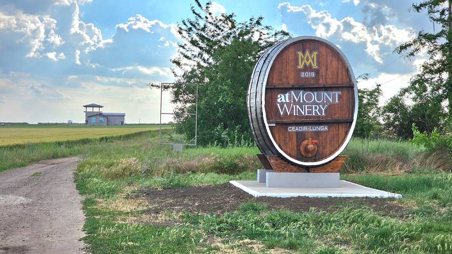 Bemount Winery entrance sign with barrel sculpture on rural vineyard road