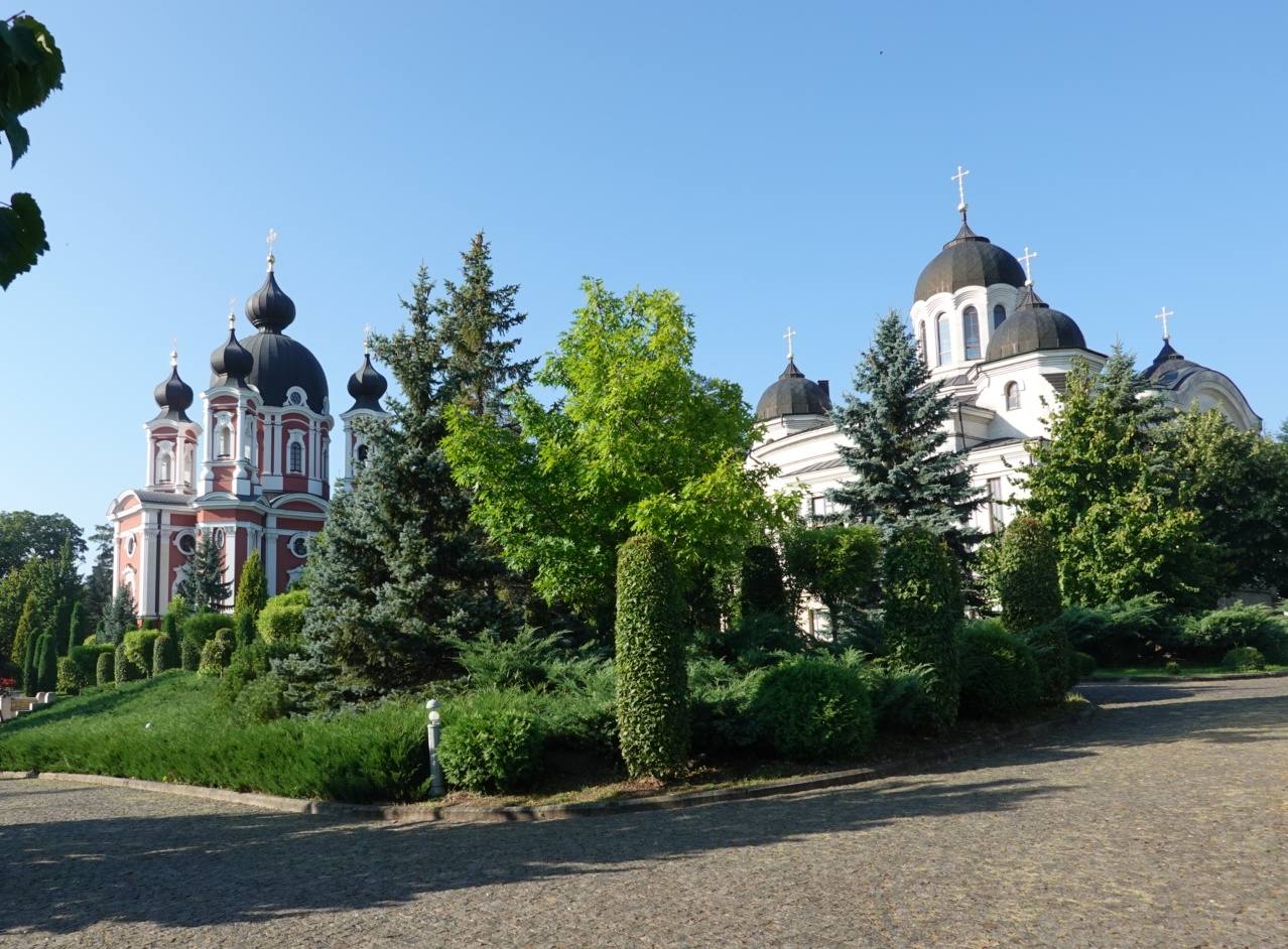 Distinctive Orthodox monastery with golden domes and manicured grounds in Moldova