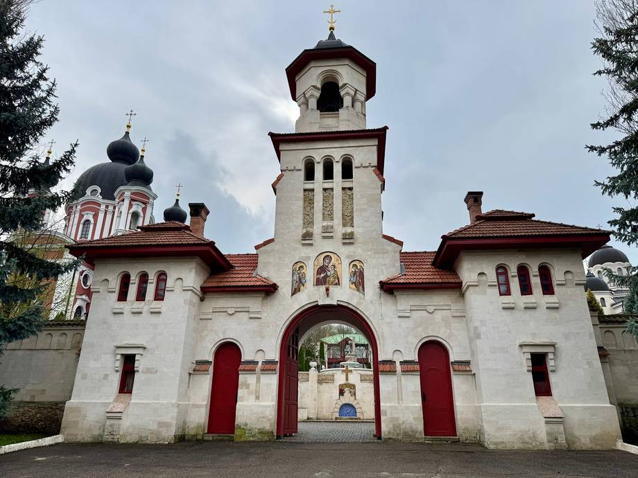 Orthodox monastery with whitewashed facade, bell tower, and traditional architectural details