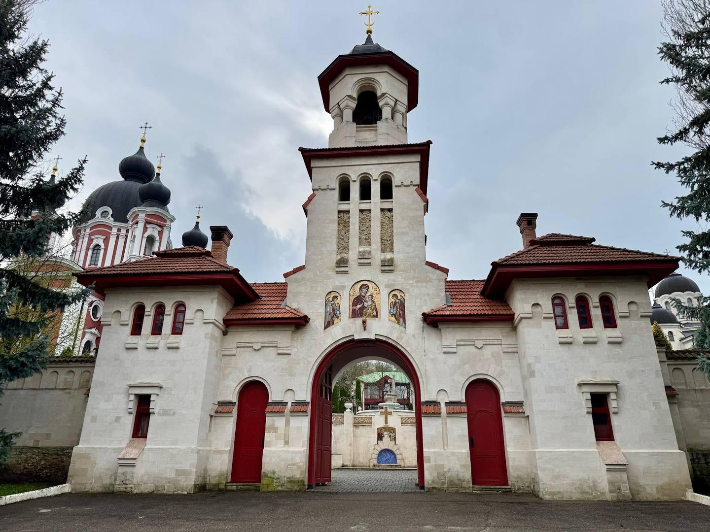 Orthodox monastery with whitewashed facade, bell tower, and traditional architectural details