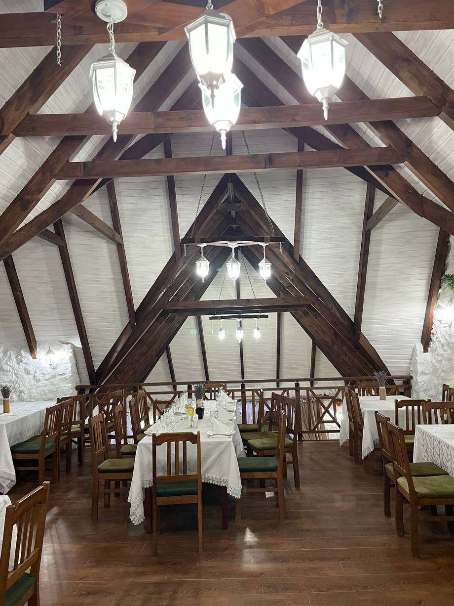 Vaulted ceiling dining room with exposed timber beams and pendant lighting