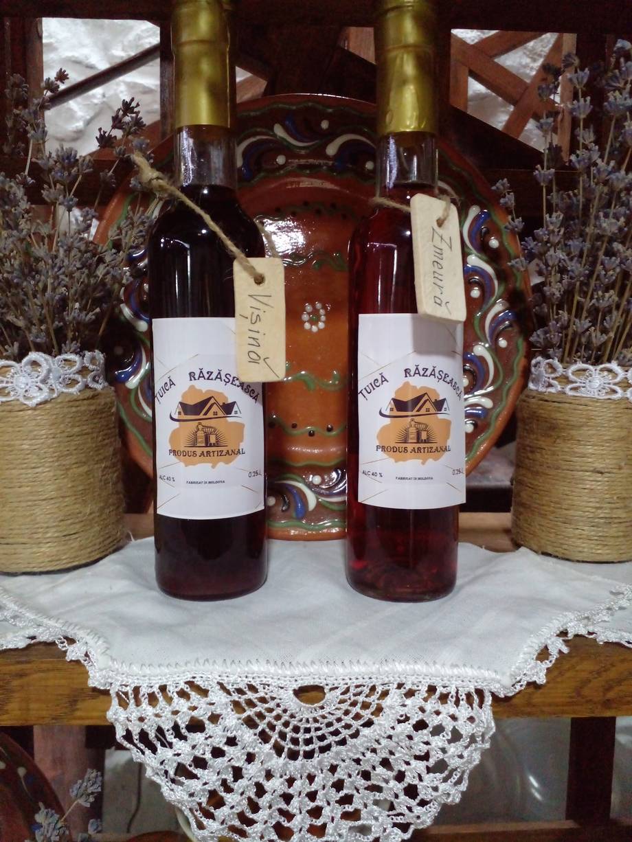 Razazov wine bottles displayed with traditional pottery and lace decor