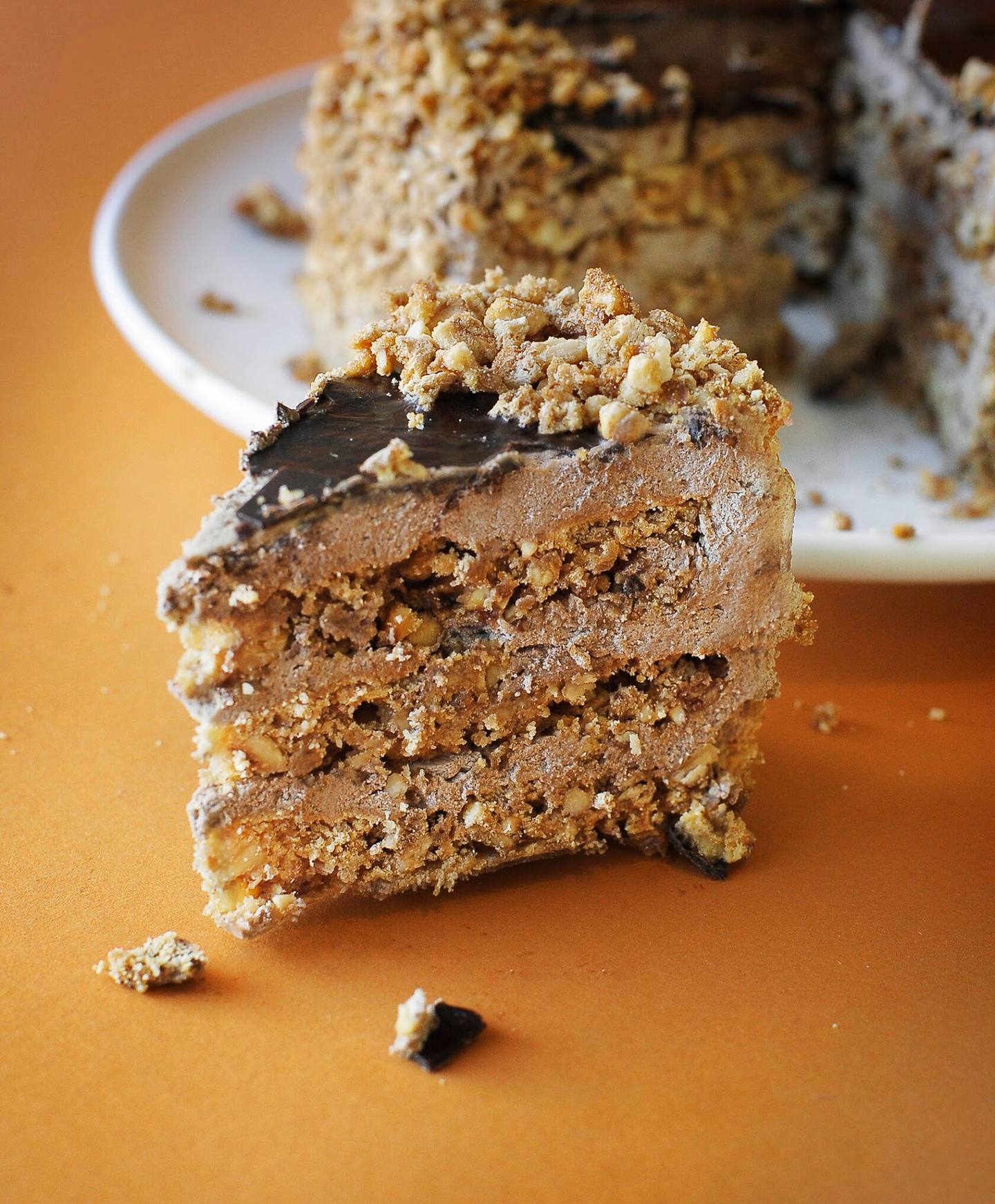 Layered chocolate cake with crumb topping and ganache coating