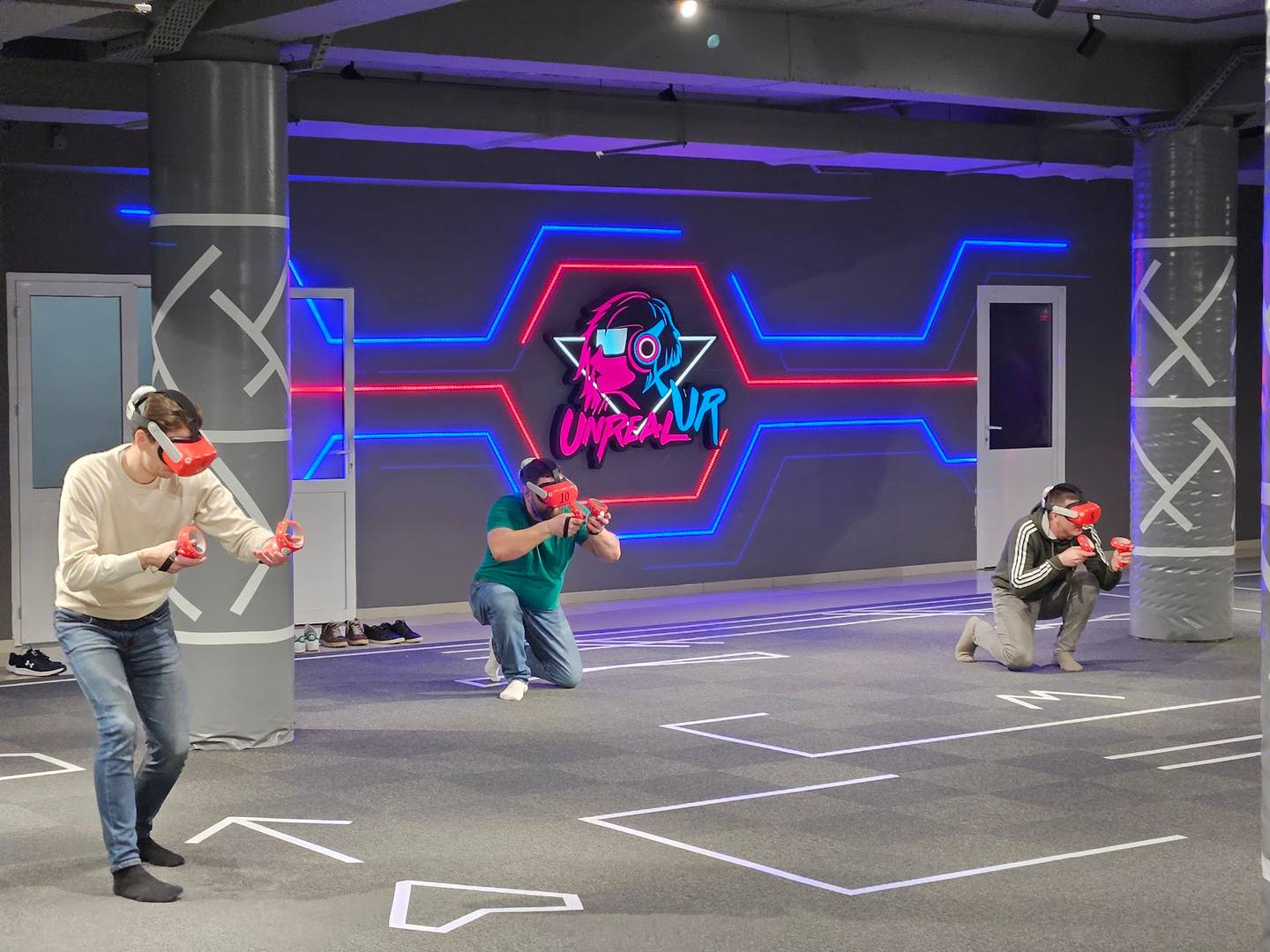 Laser tag arena with neon-lit walls and players in action