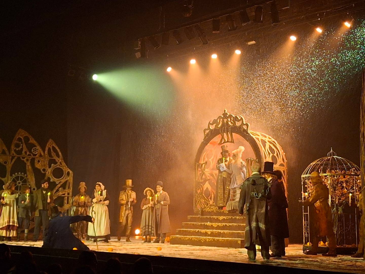 Theatrical production with dramatic stage lighting and ornate set design