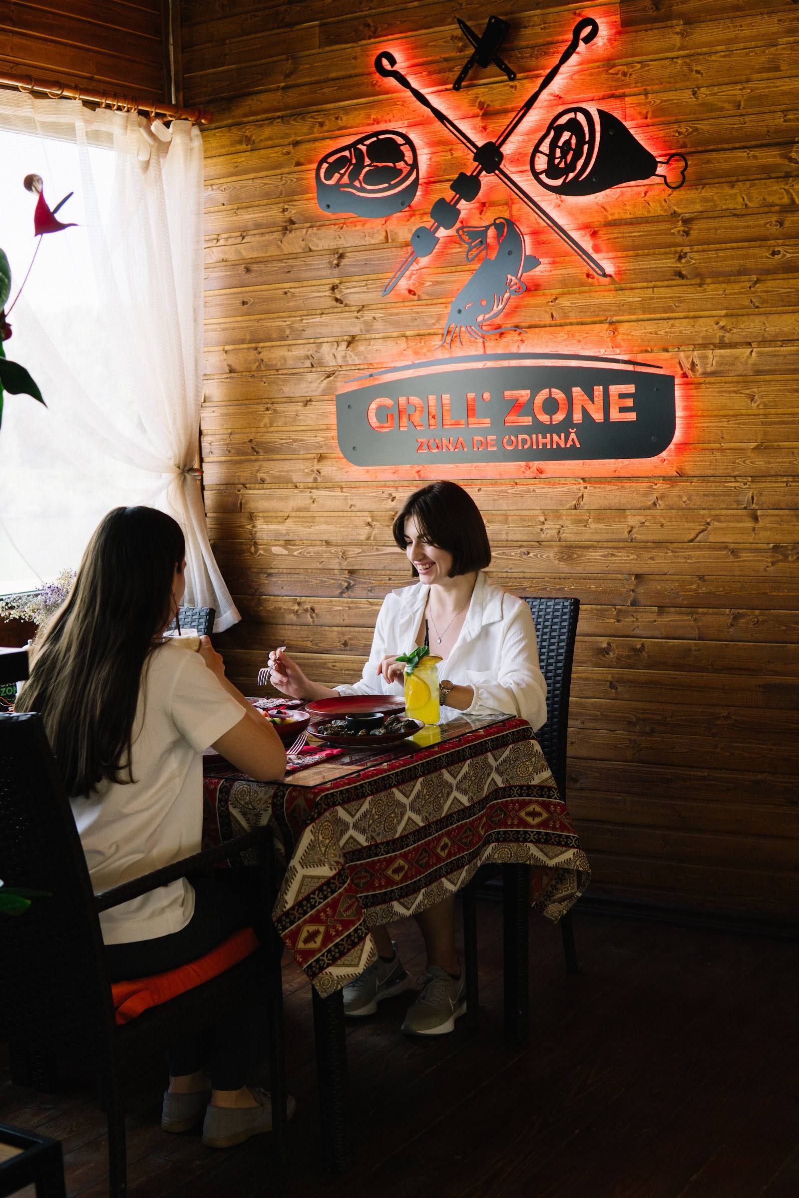 Grill Zone restaurant interior with neon signage and rustic wood decor