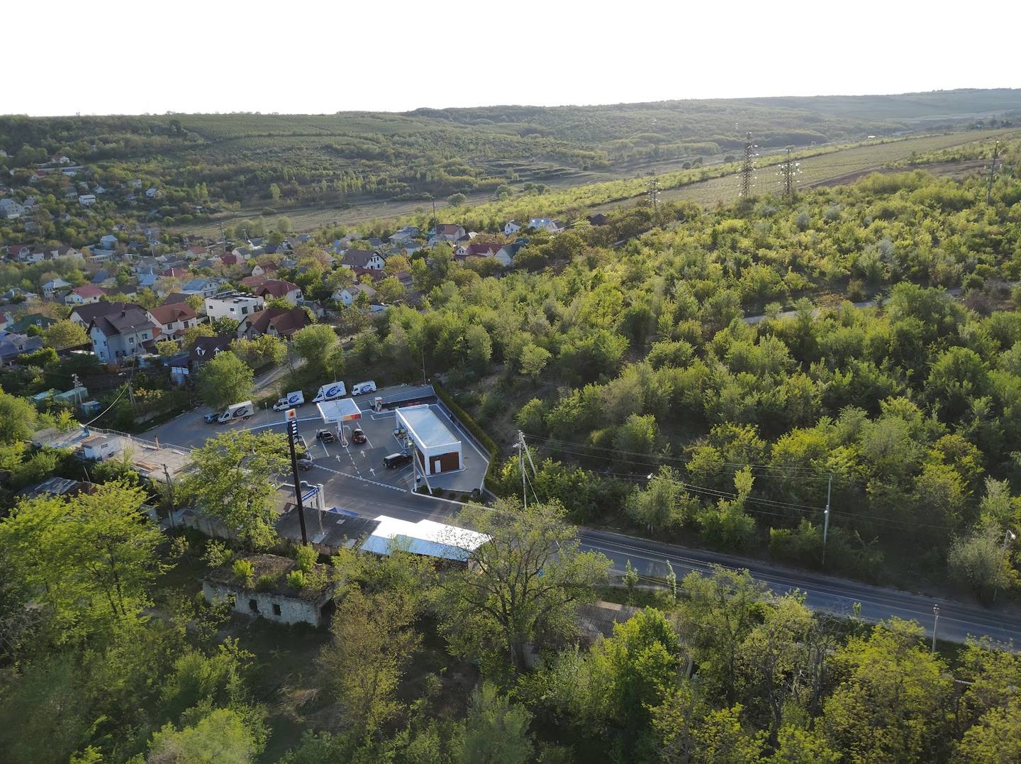 Aerial view of property in forested landscape with valley setting