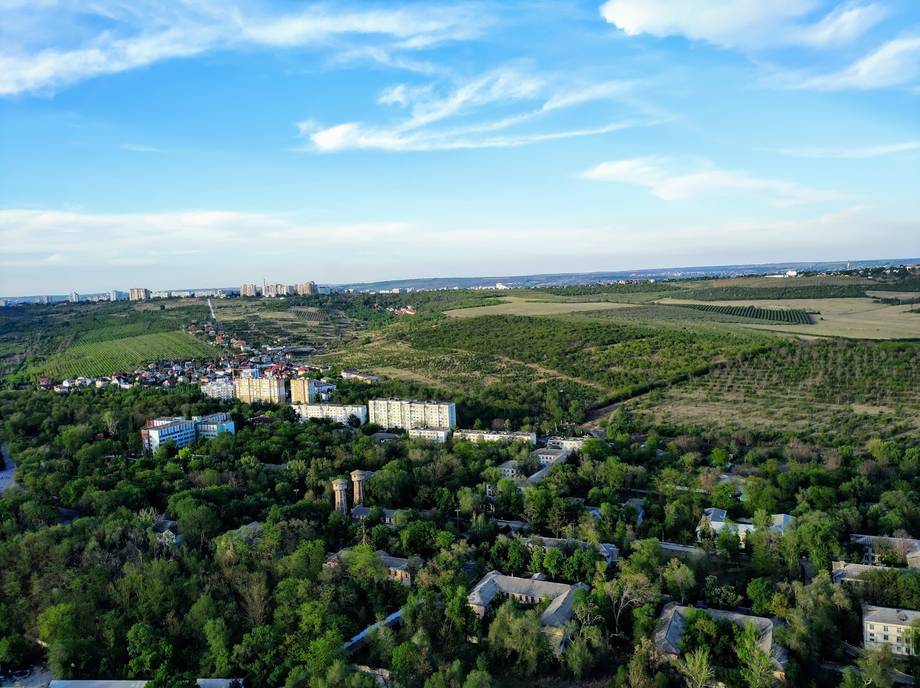 Aerial view of suburban Moldova landscape with residential buildings and green fields
