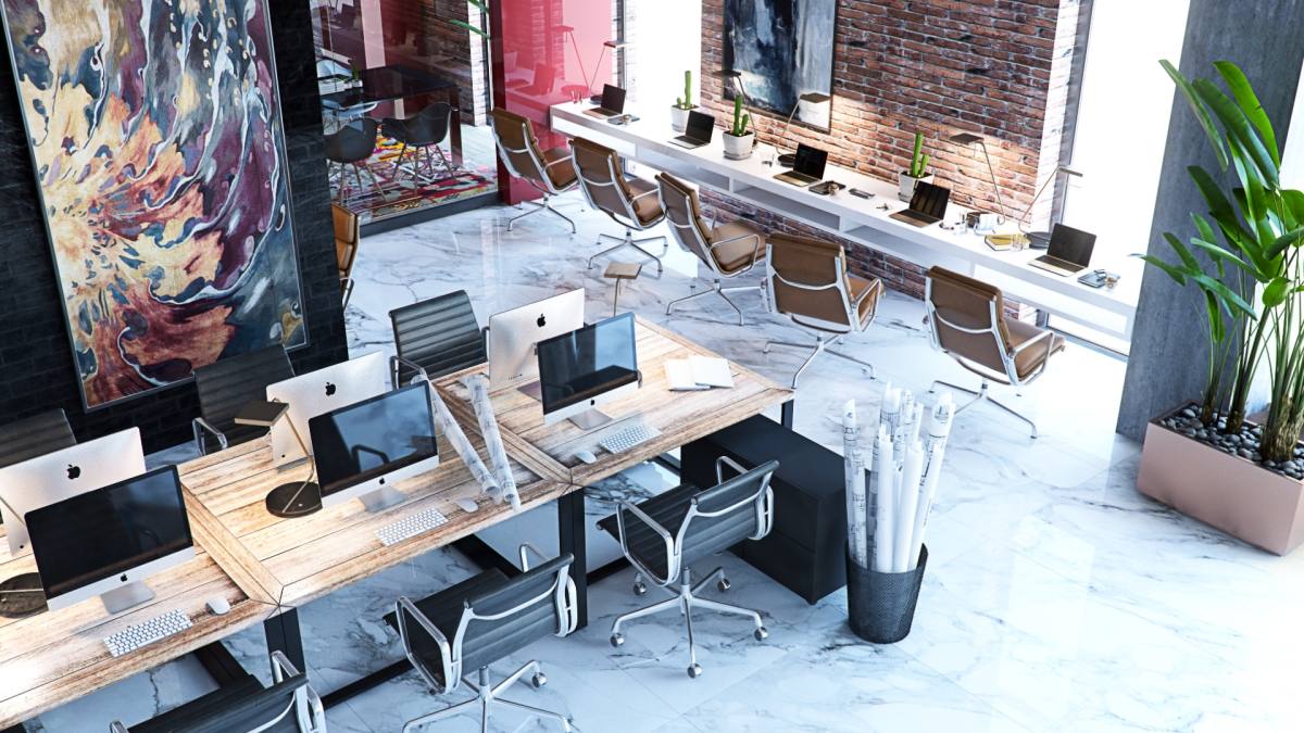 Modern open-plan office space with wooden desks, ergonomic chairs, and natural light from large windows