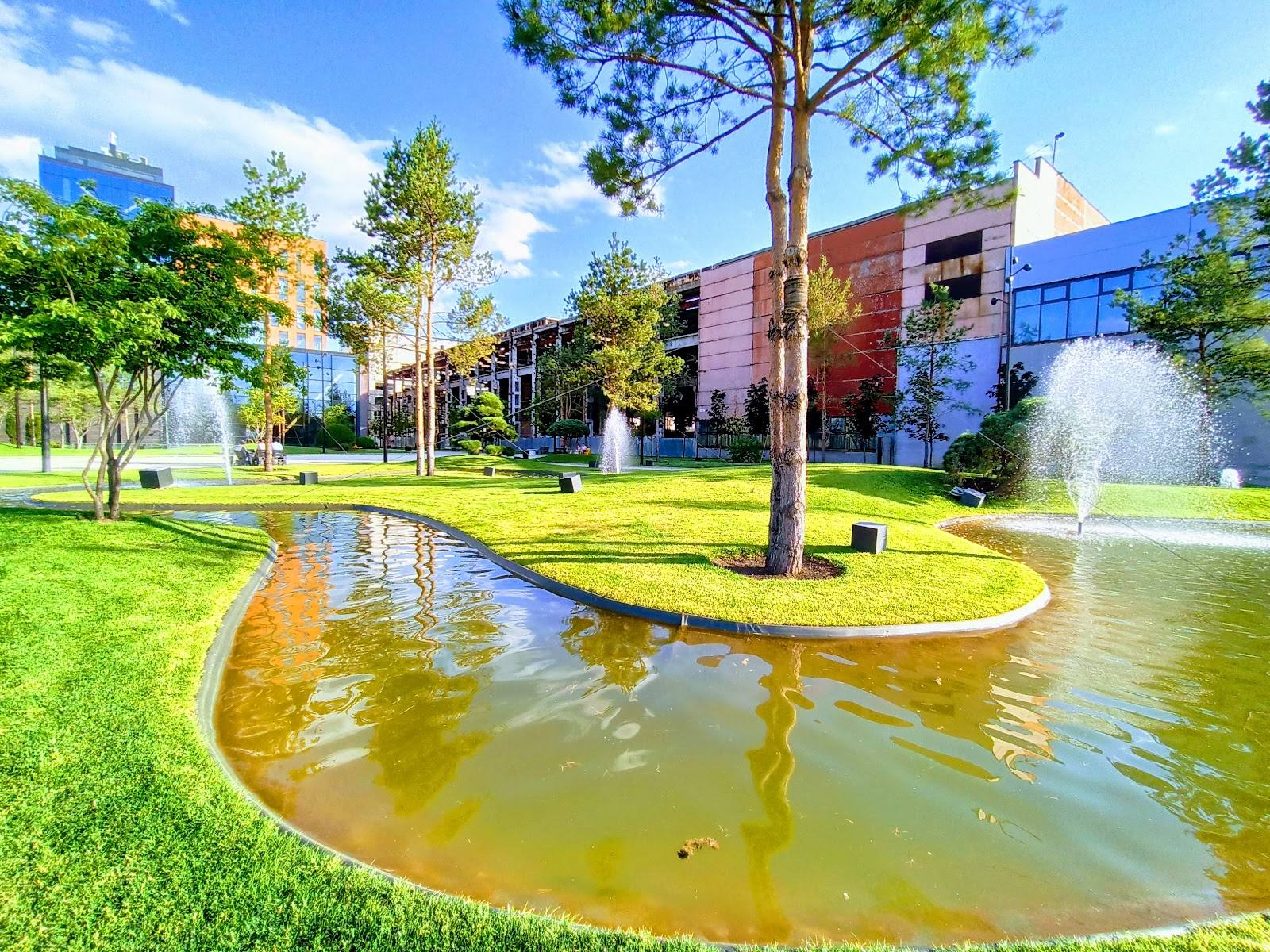 Modern venue campus with water feature, manicured grounds, and contemporary architecture