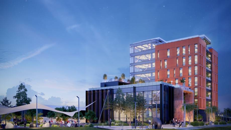 Modern mixed-use building with red brick upper floors and contemporary ground-level glass entrance