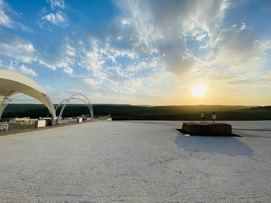 White event tents and terrace overlooking the Dniester valley at sunset