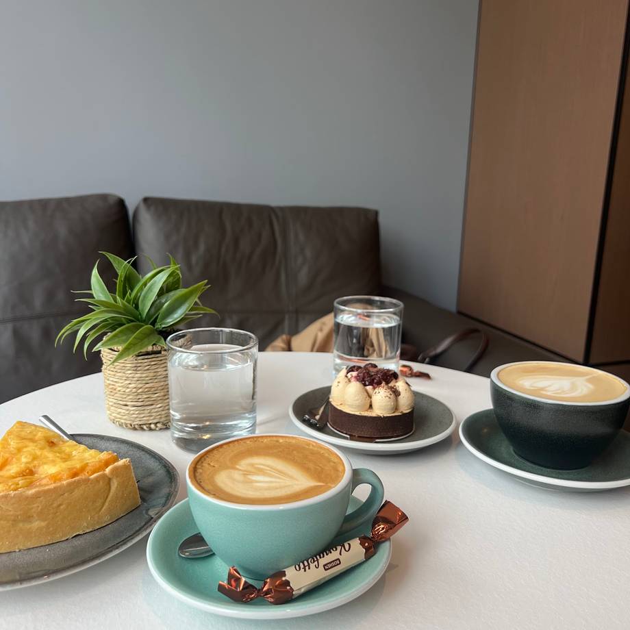 Coffee and pastries served at a bright café with modern interior and minimalist décor