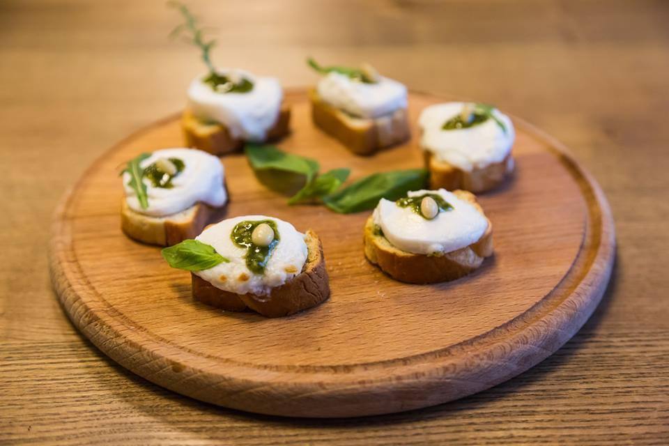 Artfully plated appetizers with herb garnish on wooden board