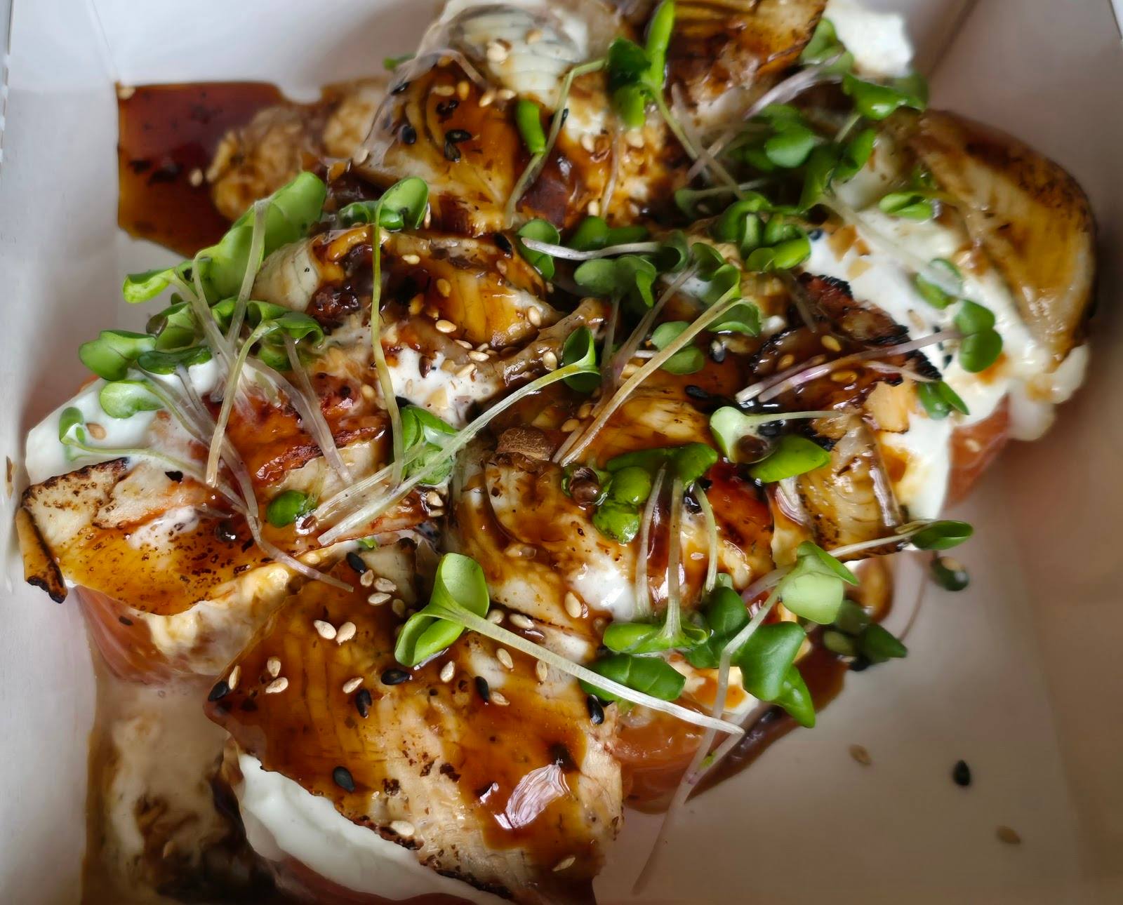 Plated appetizer with crispy potato, cream sauce, and green onion garnish