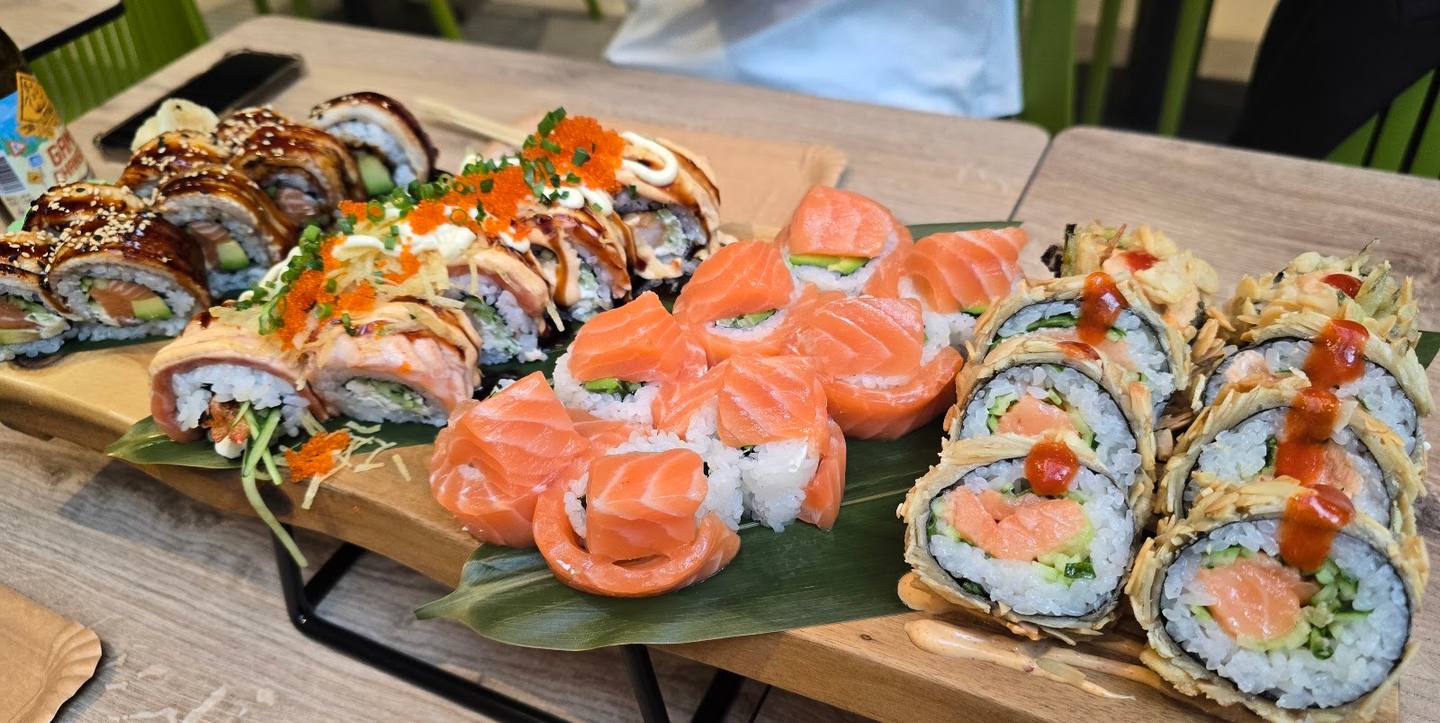 Assorted sushi and salmon rolls arranged on wooden board