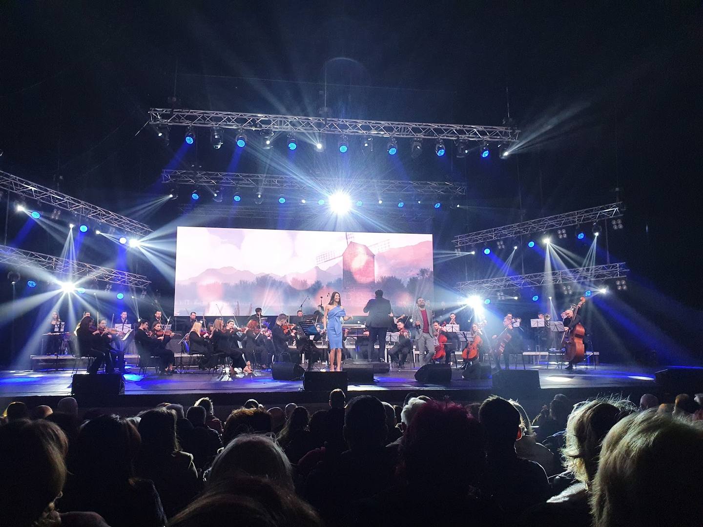 Live band performance with full stage lighting and large audience