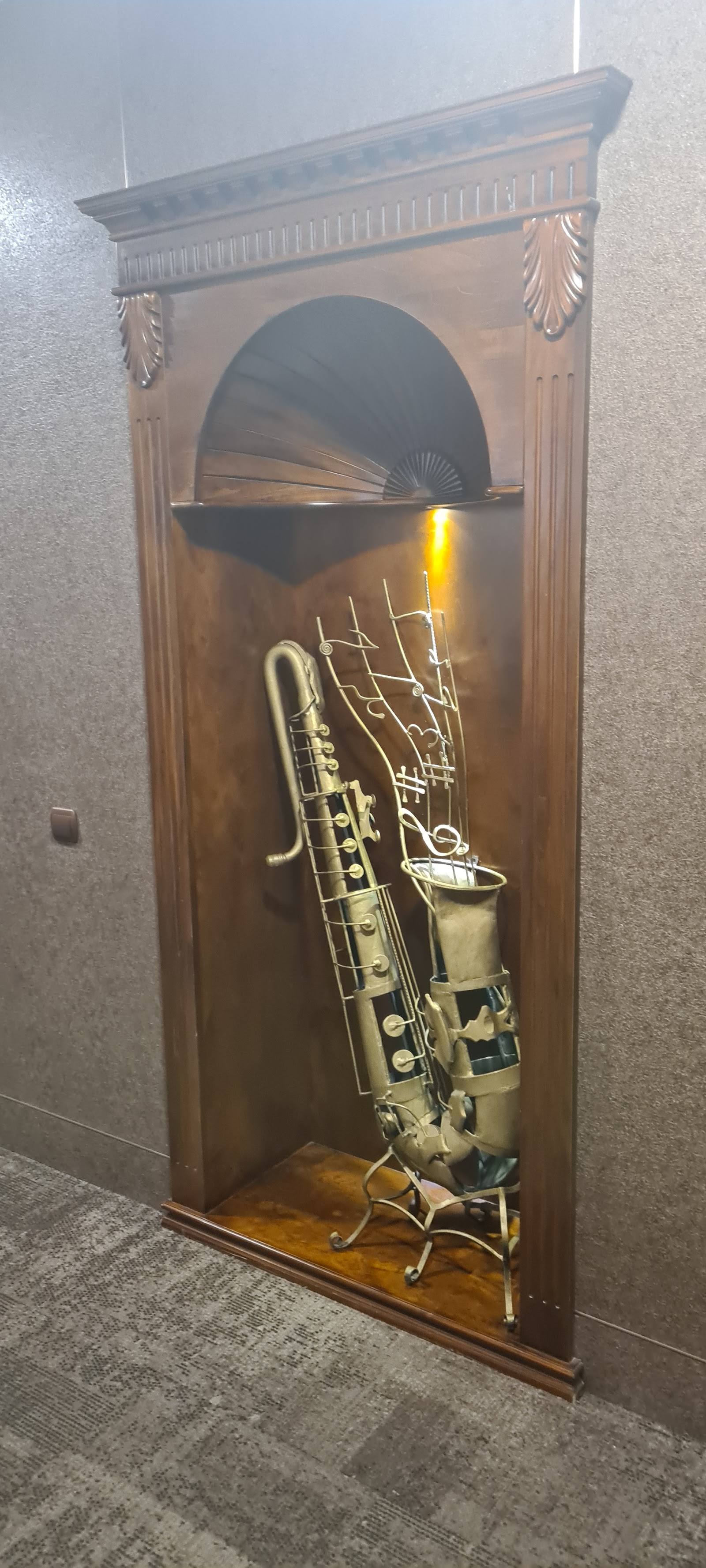 Decorative wall display case with saxophones and musical instruments