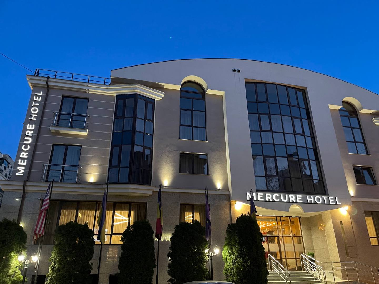 Mercure Hotel exterior facade at dusk with illuminated signage and entrance