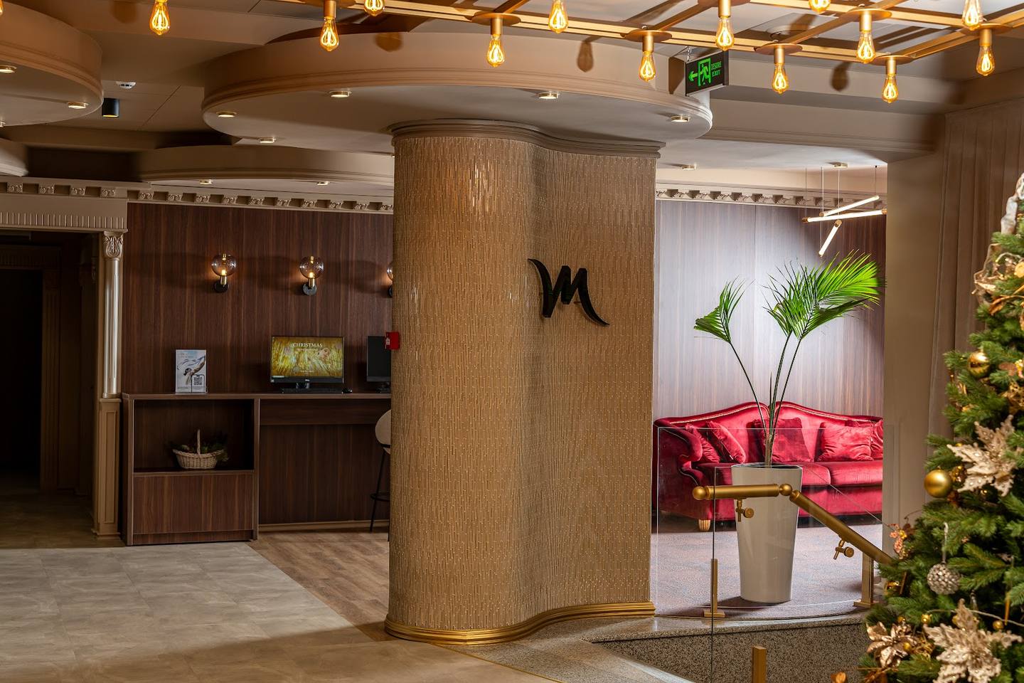 Modern hotel or spa lobby with warm wood finishes, reception desk, and contemporary seating lounge