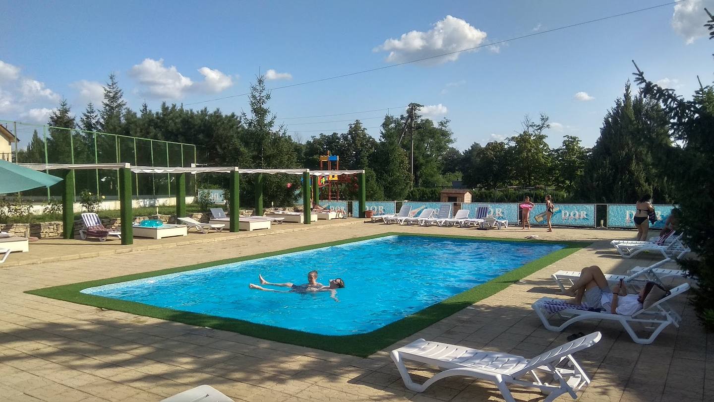Outdoor swimming pool with lounge chairs and activity zones