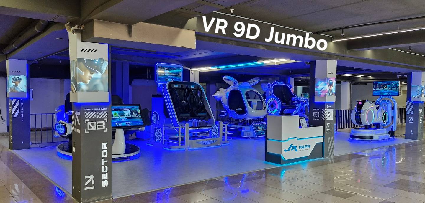VR 9D Jumbo gaming arena with blue-lit immersive experience pods and motion simulator stations