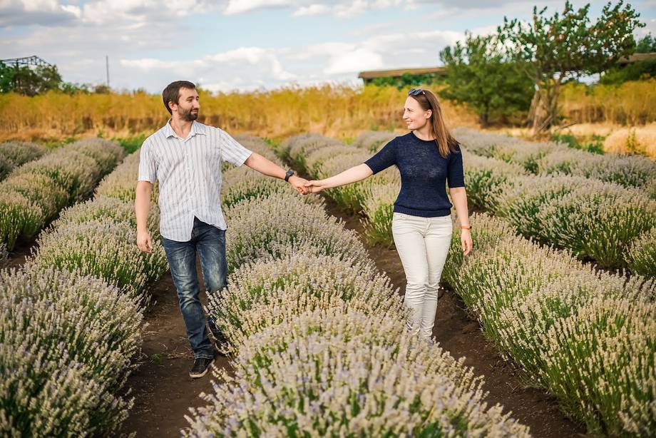 Couple walking through lavender fields in Moldova during golden hour