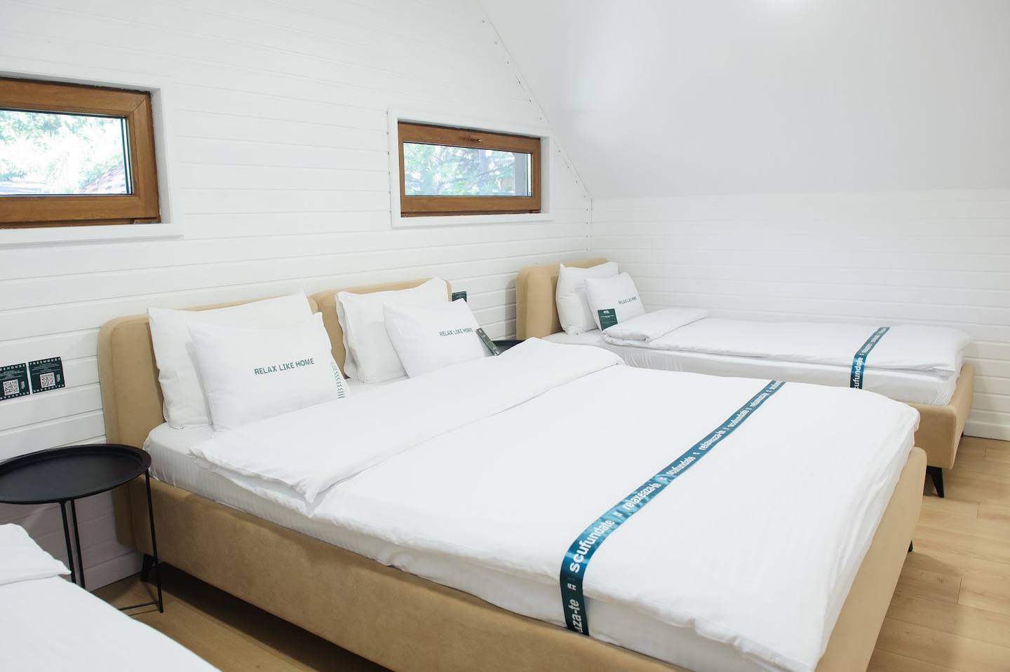 Clean modern guest room with twin beds and wooden accents