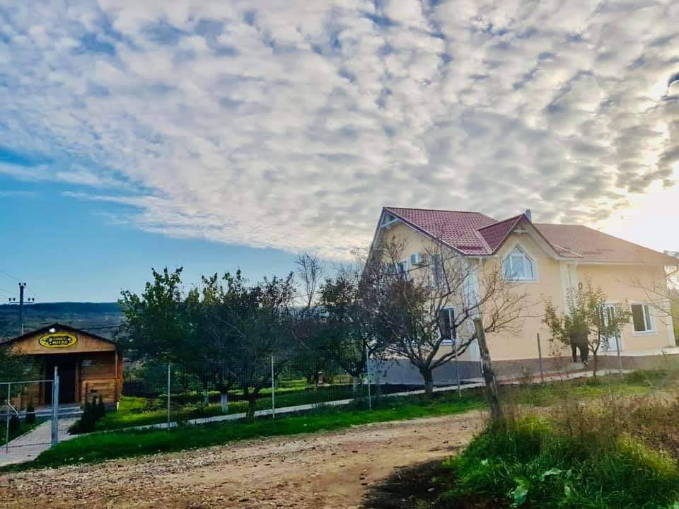 Orthodox monastery with chapel and grounds under blue sky