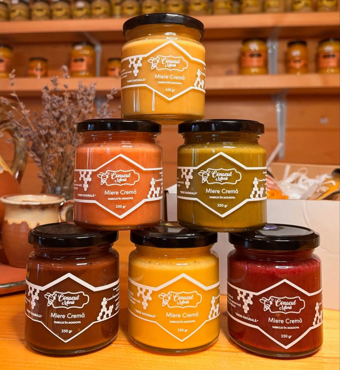 Artisanal jam jars in pyramid arrangement with pantry shelves in background