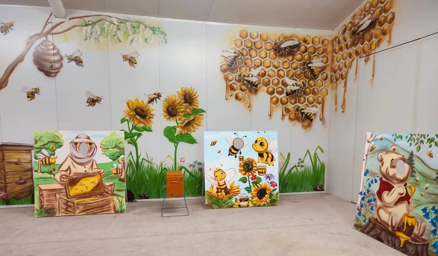 Children's activity space with bee-themed decorations and interactive wall displays