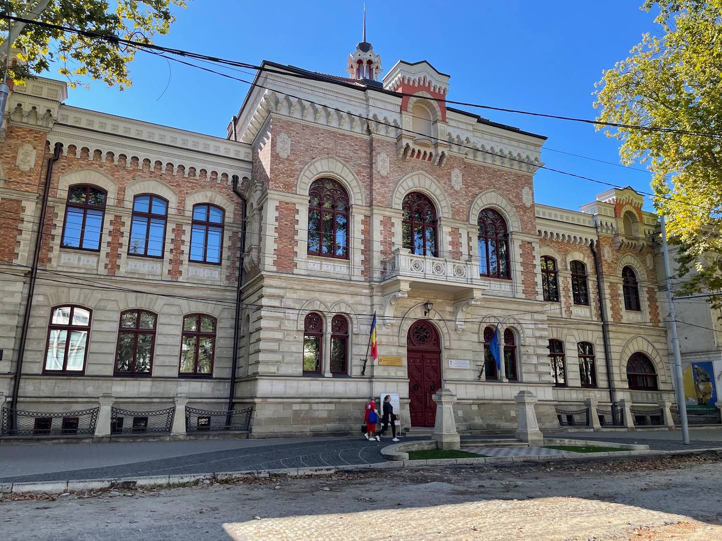 Historic stone fortress building with ornate towers and archways in classical Eastern European architectural style