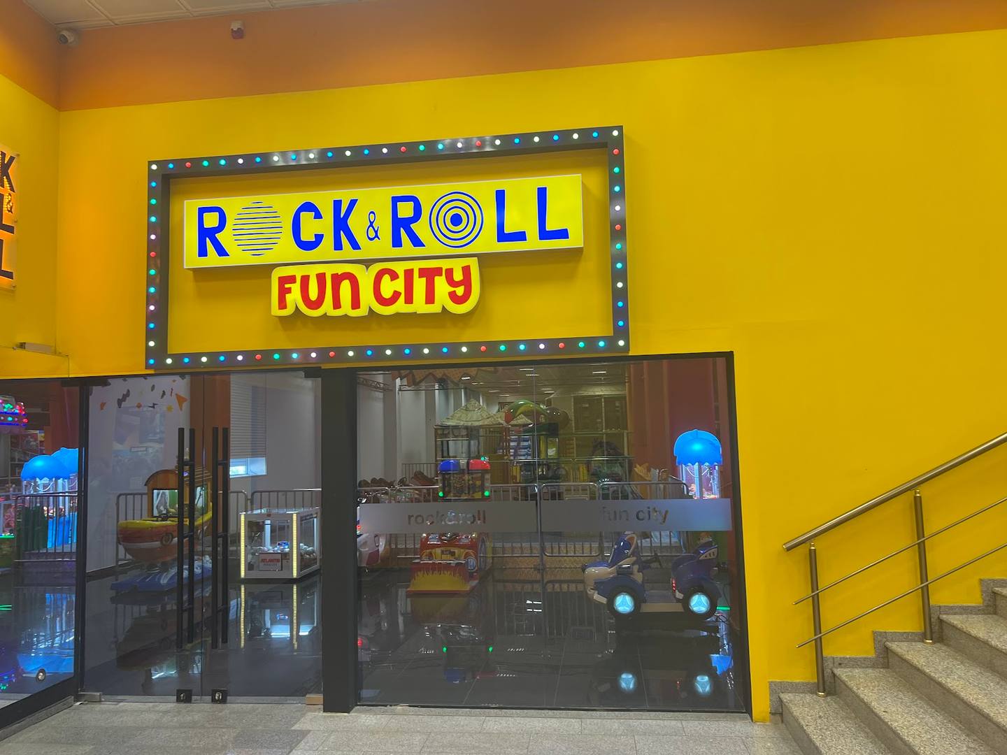 Rock & Roll Fun City entertainment venue entrance with illuminated marquee sign
