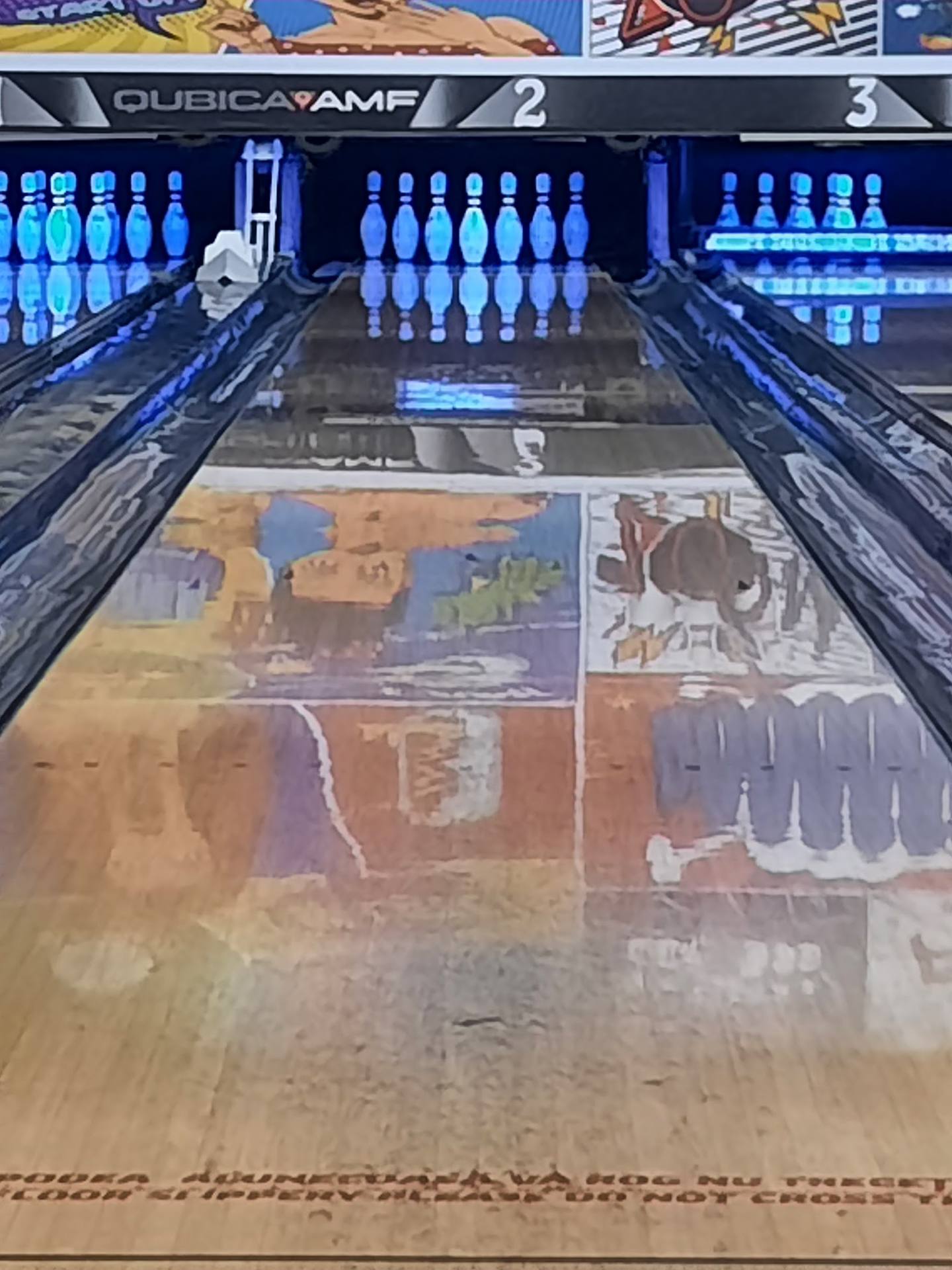 Bowling lane with illuminated pins and scoring display at Dubai Camp venue