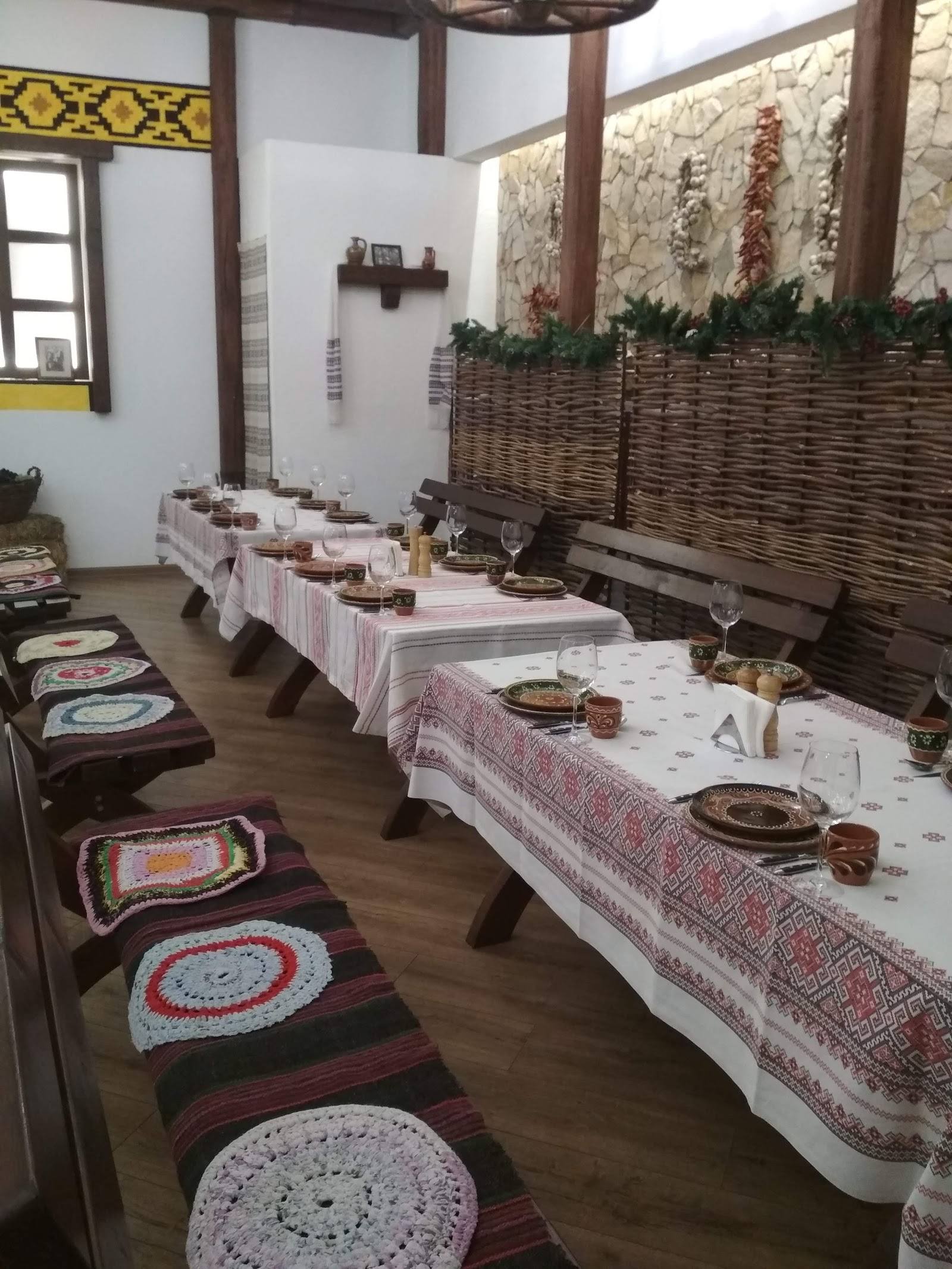 Traditional dining room with long tables, ethnic textiles, and woven decorative elements