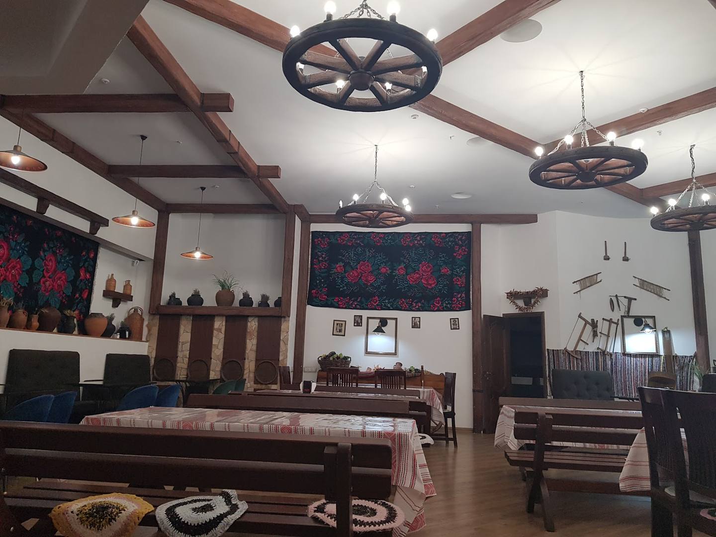 Western-themed event space with wood-beam ceiling and wagon-wheel chandeliers