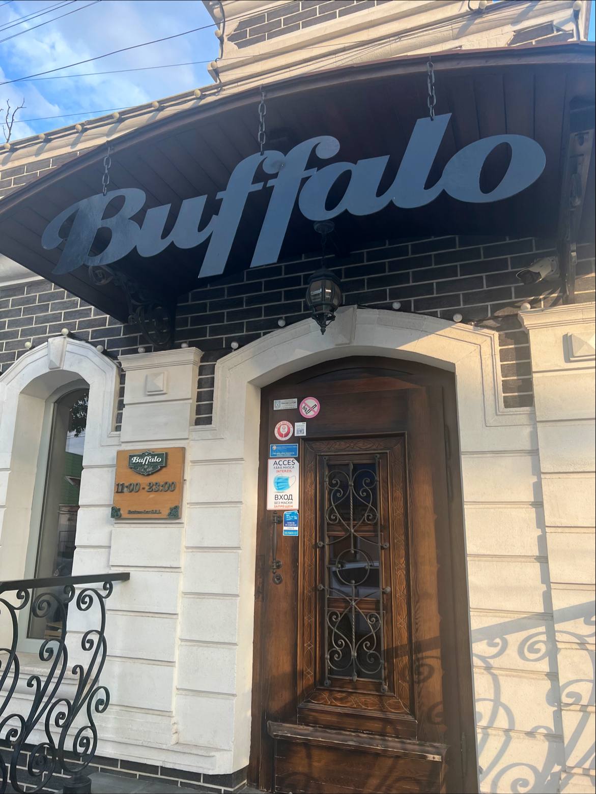 Buffalo storefront with iconic signage and ornate wooden door entrance