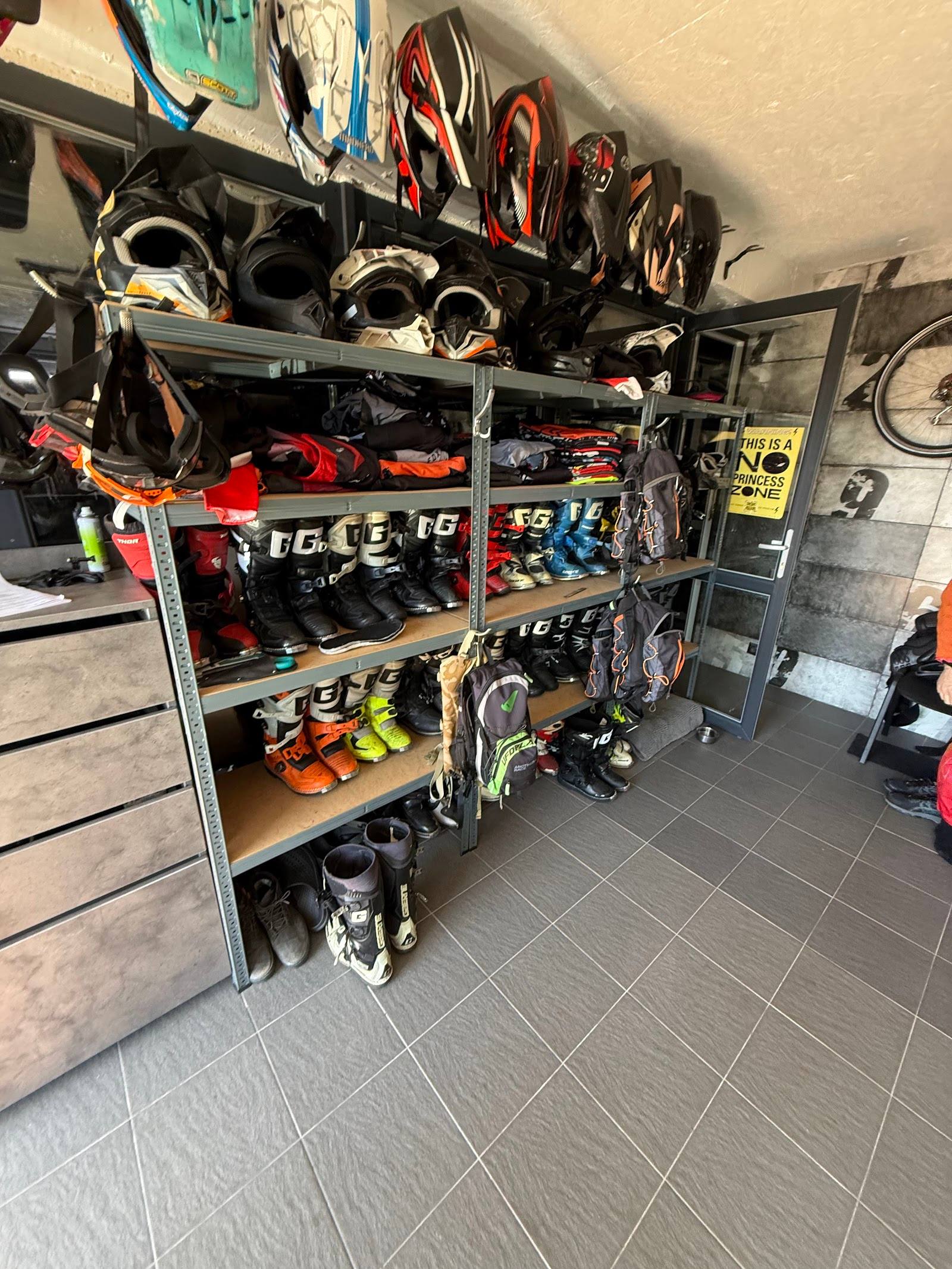 Equipment storage shelving with helmets, protective gear, and activity supplies