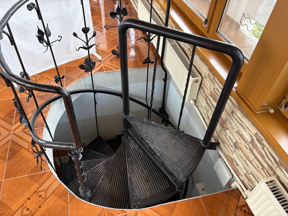 Spiral staircase descent in a modern circular tower space