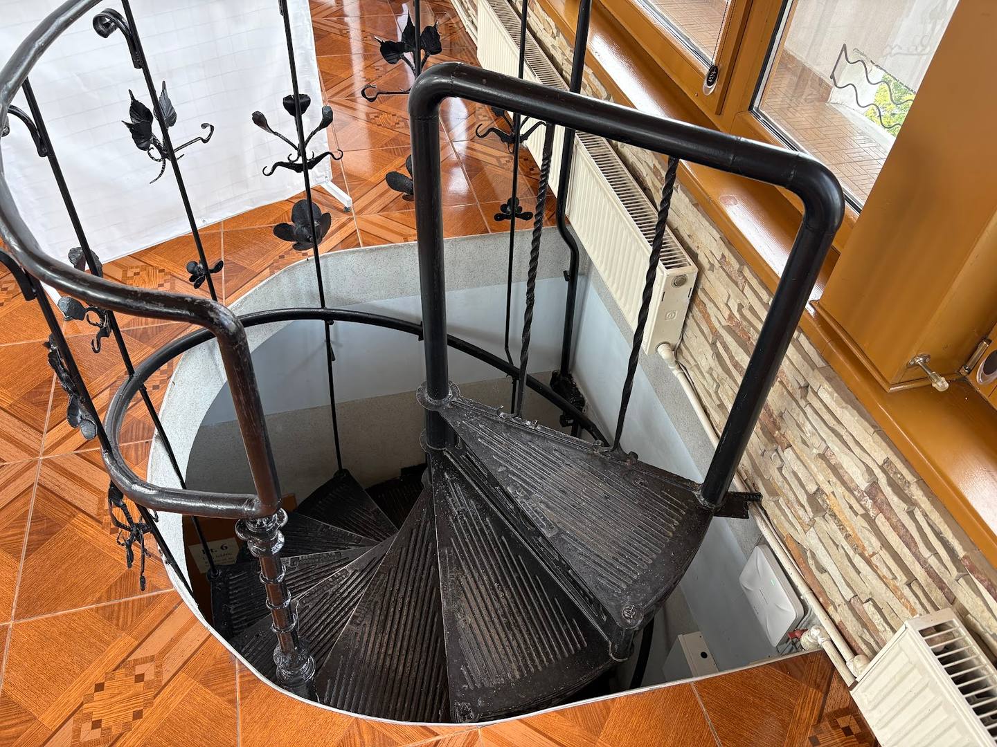Spiral staircase descent in a modern circular tower space
