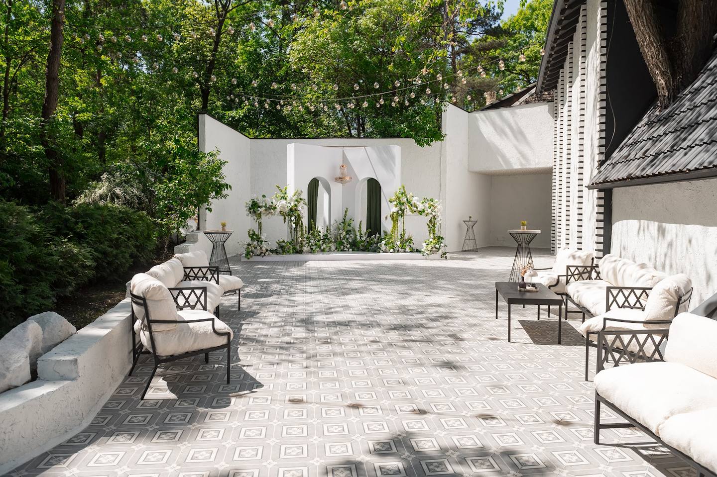 Elegant outdoor terrace with modern white pavilion and seating area