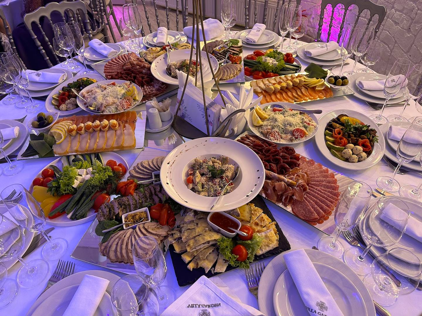 Festive catering spread with seafood, meats, and fresh dishes at an event dinner