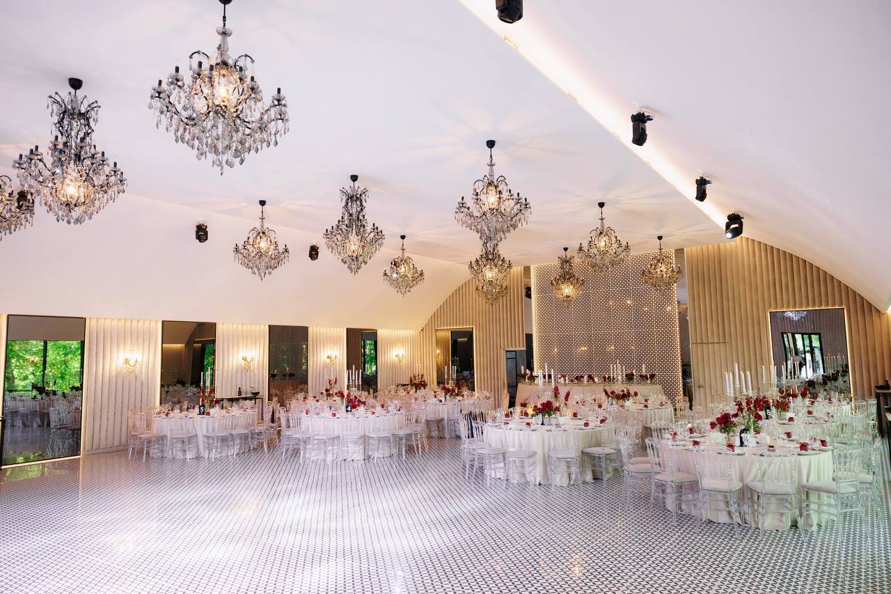 Grand reception hall with crystal chandeliers and elegant table setup