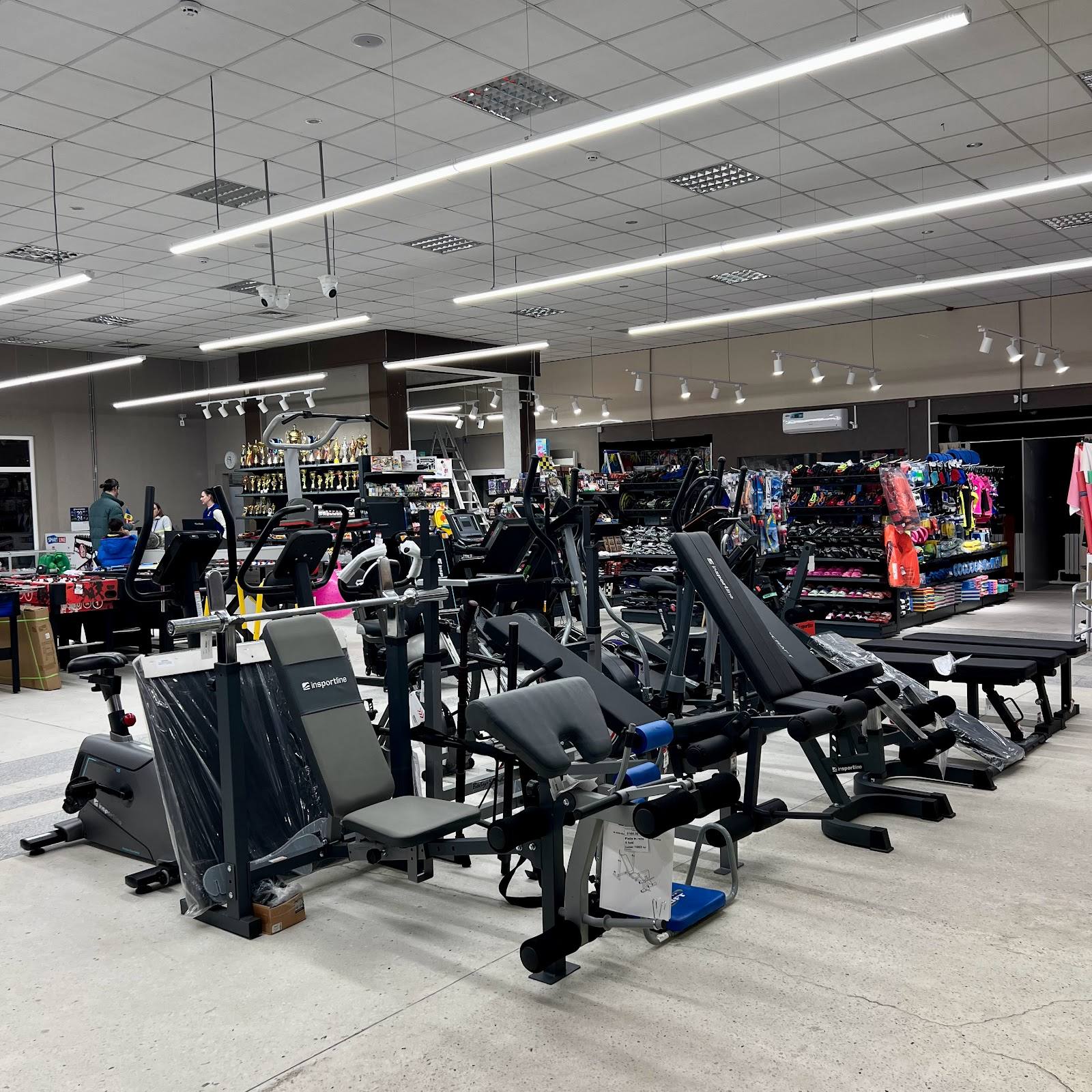 Bright, modern fitness center with cardio equipment and weight machines on polished floor