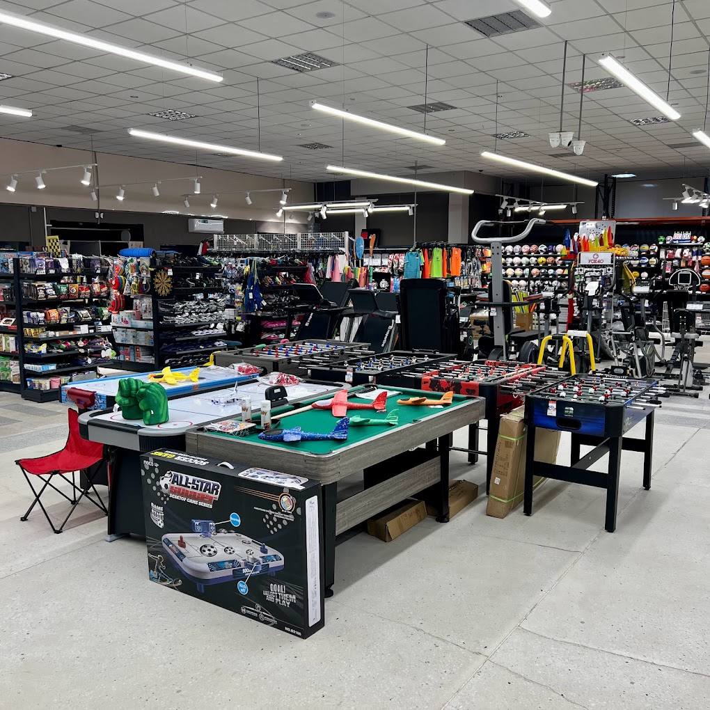Indoor entertainment venue with pool table, arcade games, and merchandise retail space