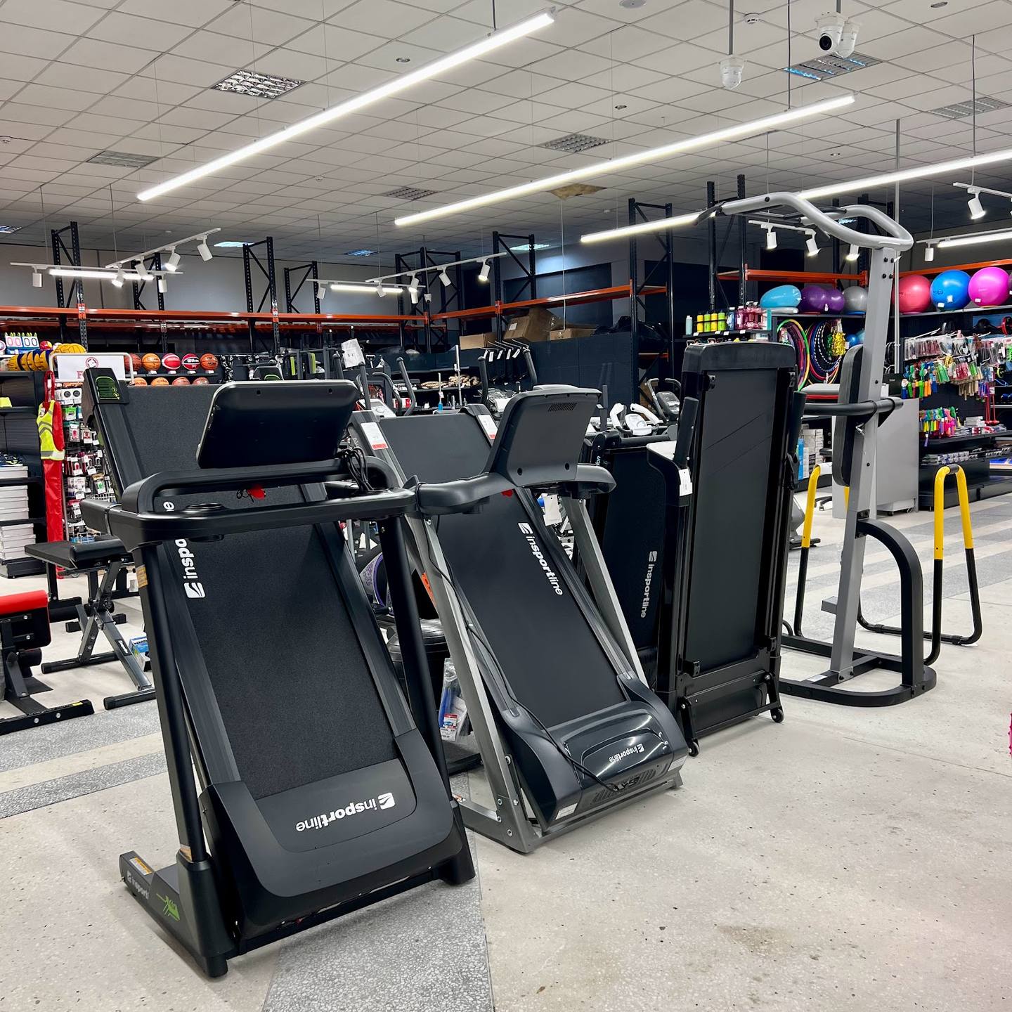 Modern fitness studio interior with treadmills and cardio equipment on display