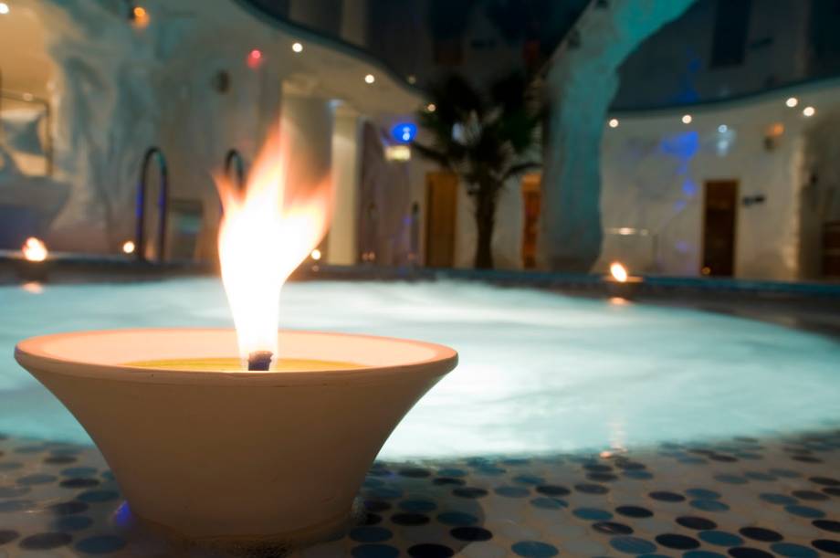 Fire bowl with architectural courtyard and ambient lighting at night
