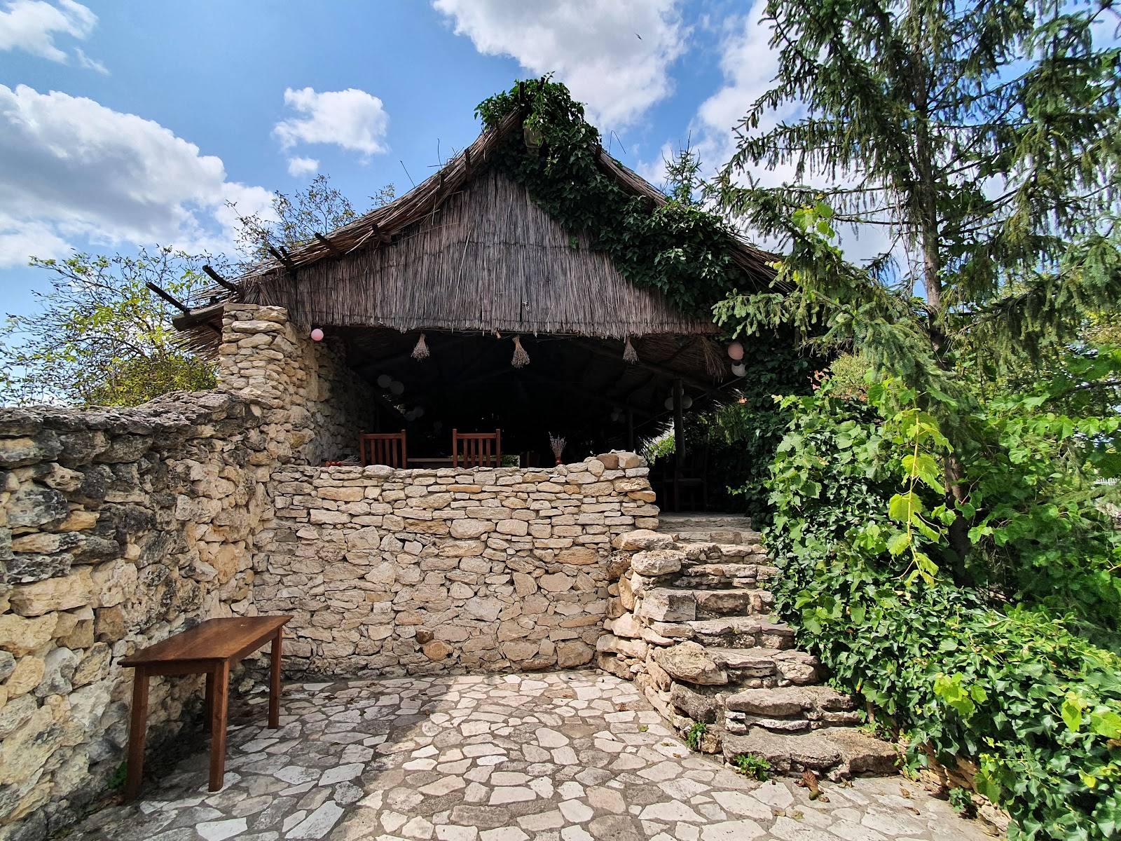 Historic stone monastery with thatched roof and ivy-covered walls