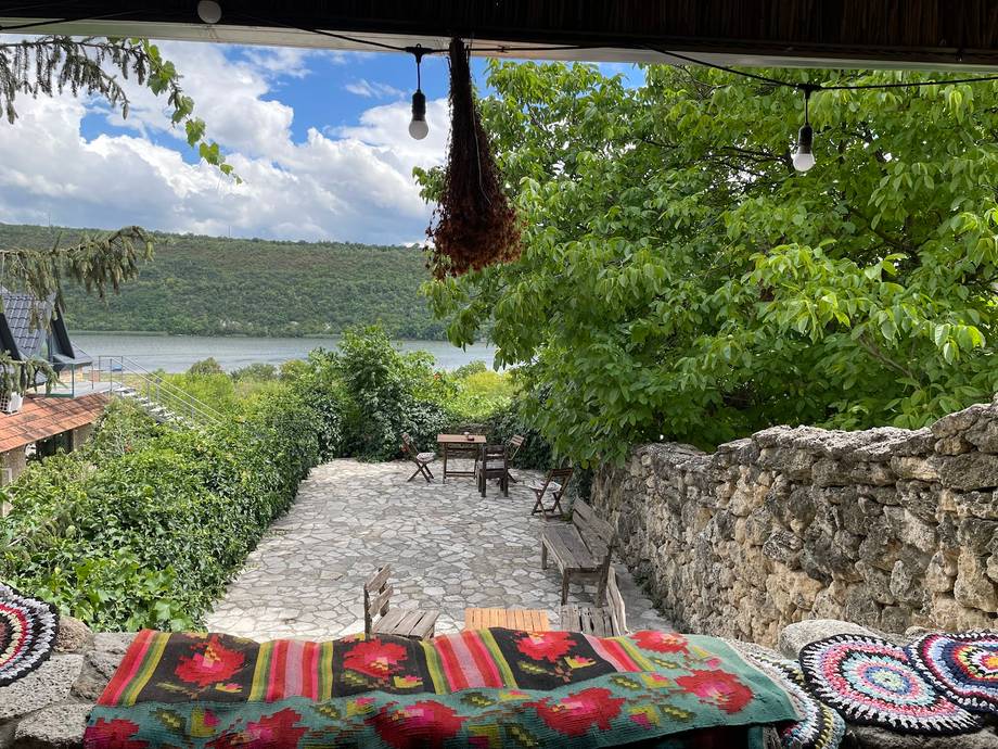 Lakeside terrace with traditional textiles overlooking scenic water and mountains