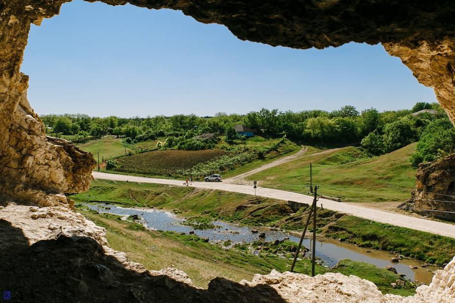 Panoramic cave view overlooking river valley and countryside landscape